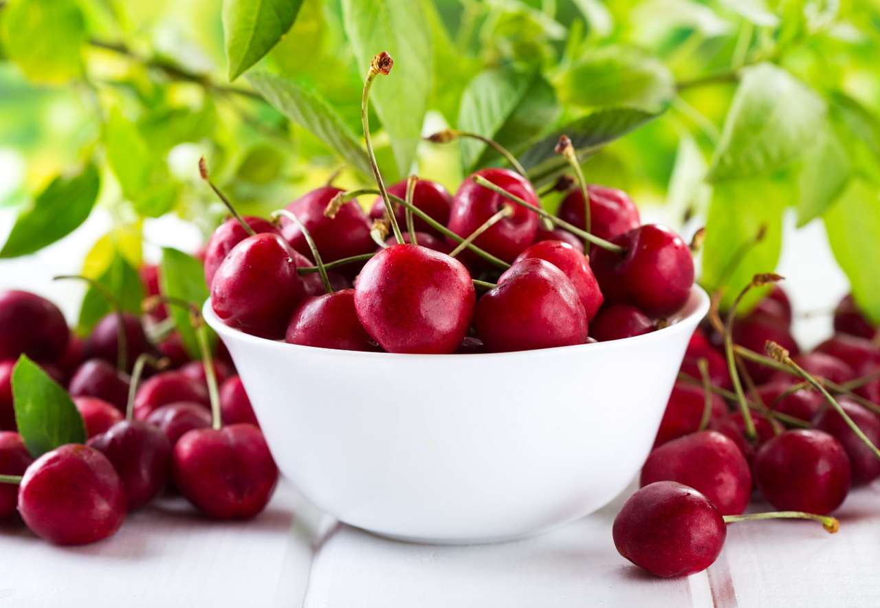 Bowl of cherries on a white table puzzle online from photo