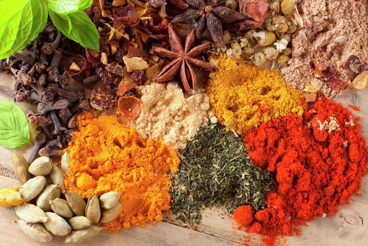 Colorful herbs and spices on a wooden table online puzzle