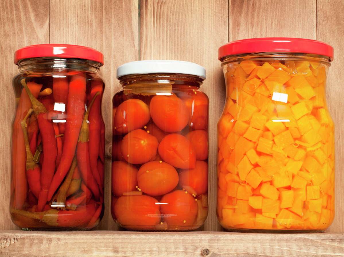 Jars of preserved vegetables on a wooden shelf online puzzle