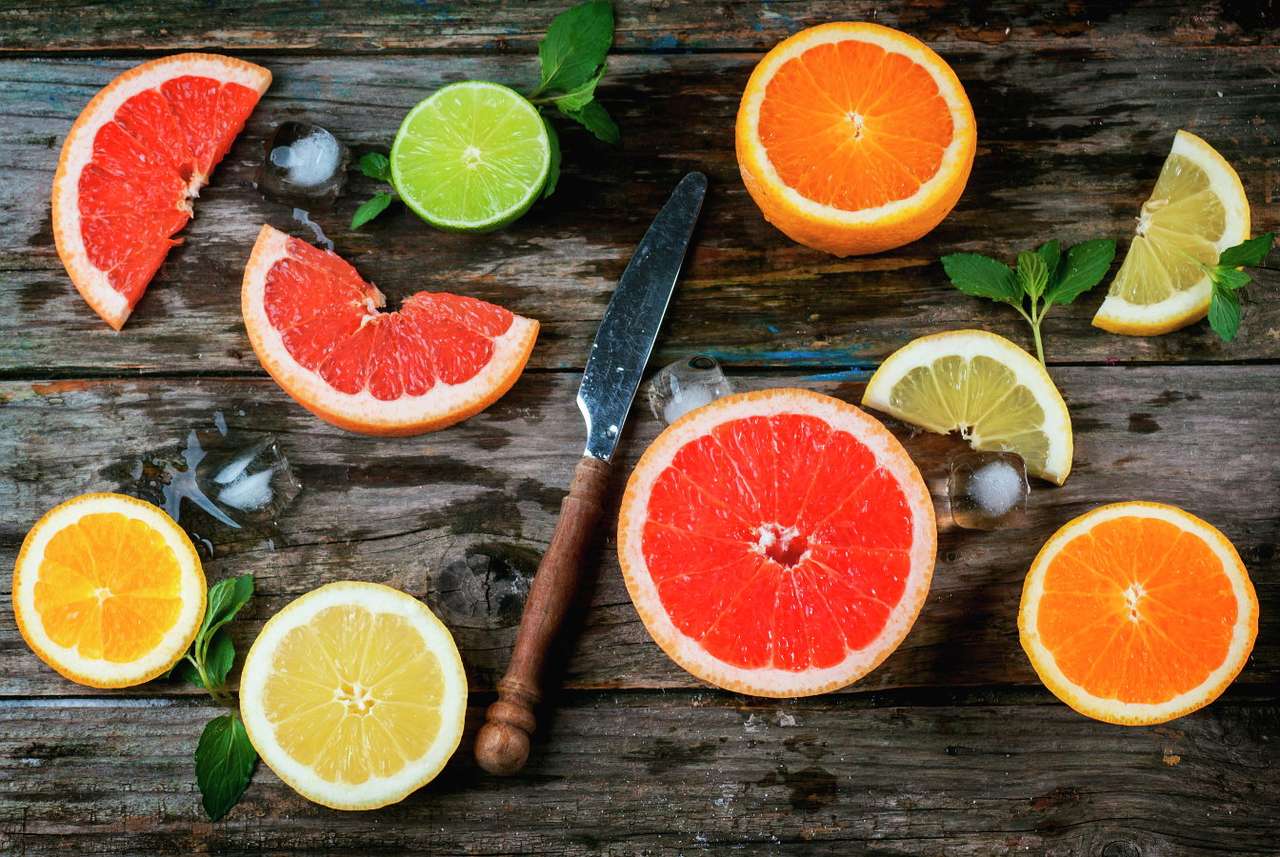 Slices of citrus fruit on a wooden table puzzle online from photo