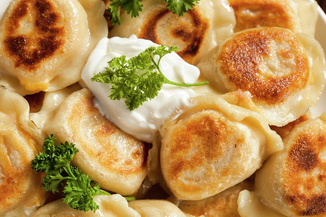 Traditional Polish dumplings served with sour cream puzzle online from photo