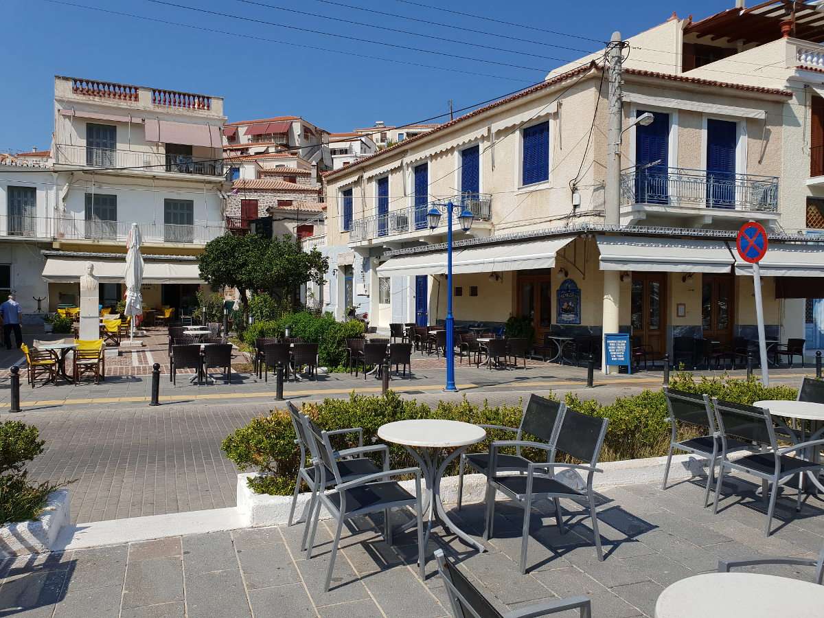Square with cafes in Poros (Greece) puzzle online from photo