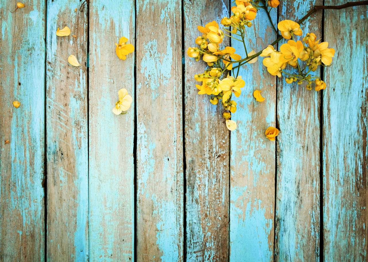 Yellow flowers on a wooden fence online puzzle