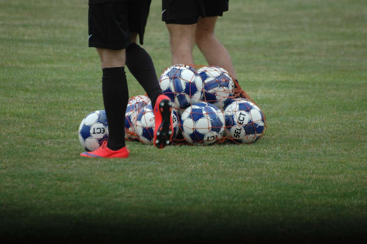 много футбольных мячей с ногами на газоне онлайн-пазл
