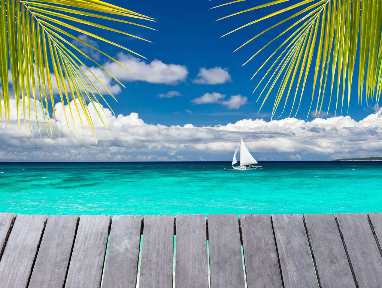Wooden pier with view on sailboat in the ocean puzzle online from photo