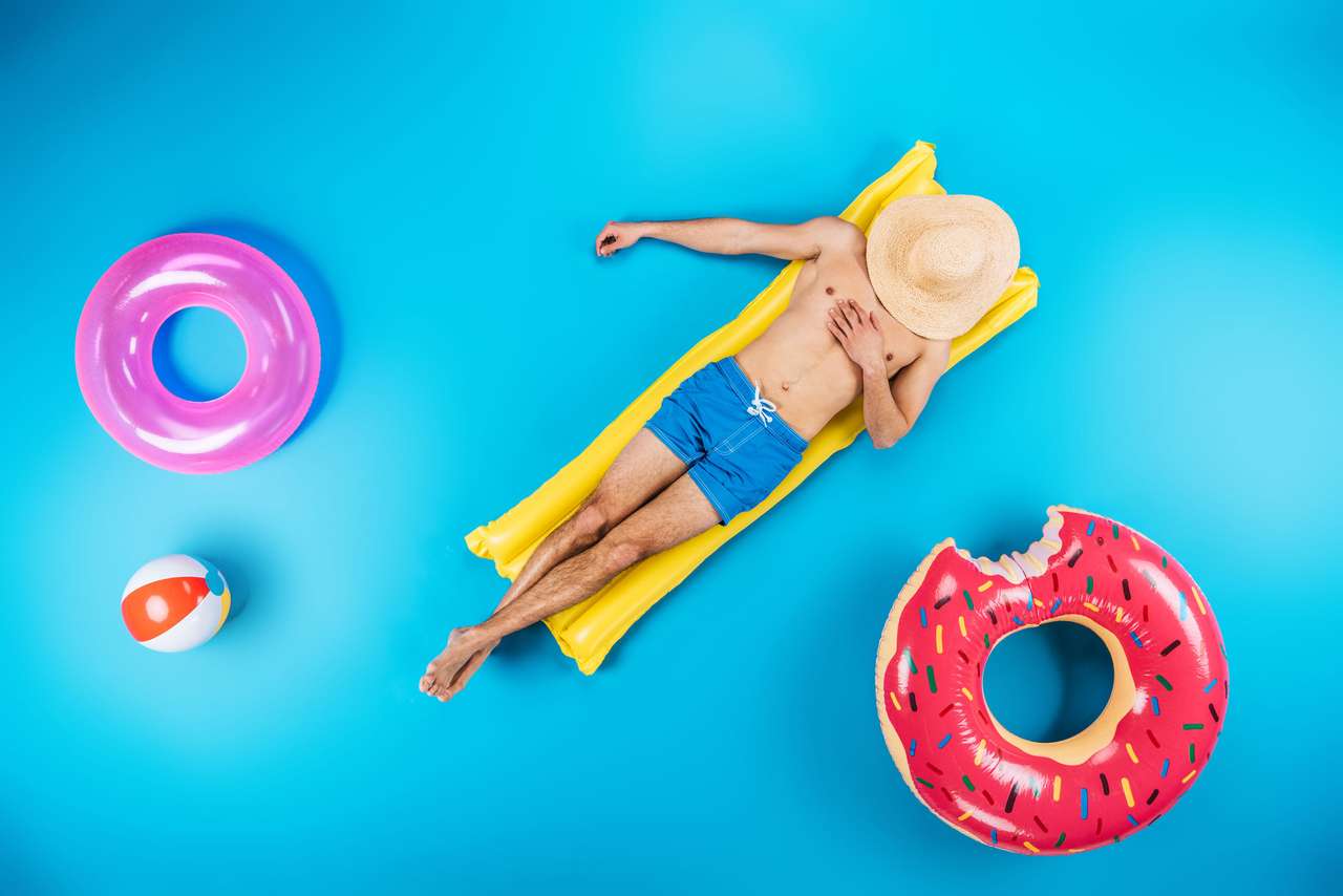 Young man resting on inflatable mattress puzzle online from photo