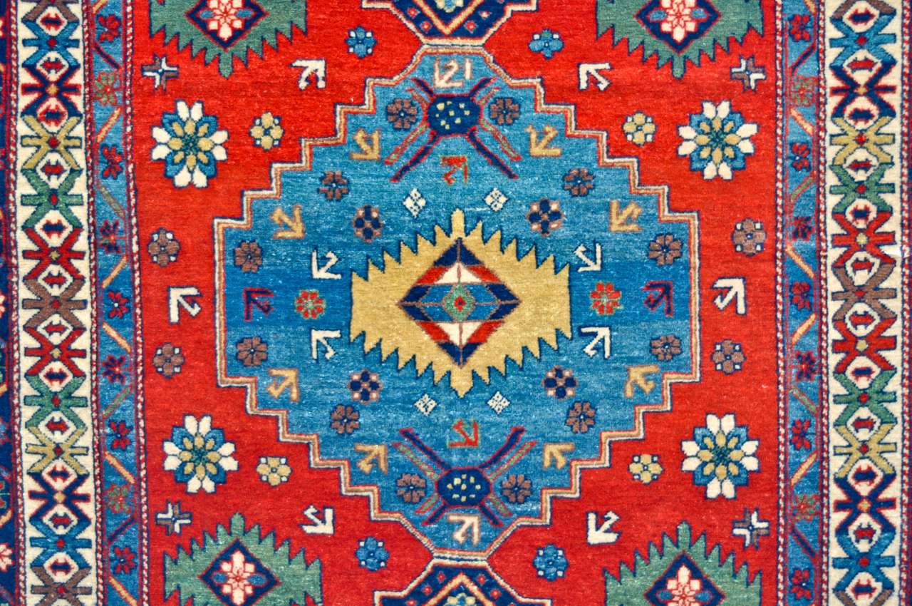 Colored wool handmade carpet closeup puzzle online from photo