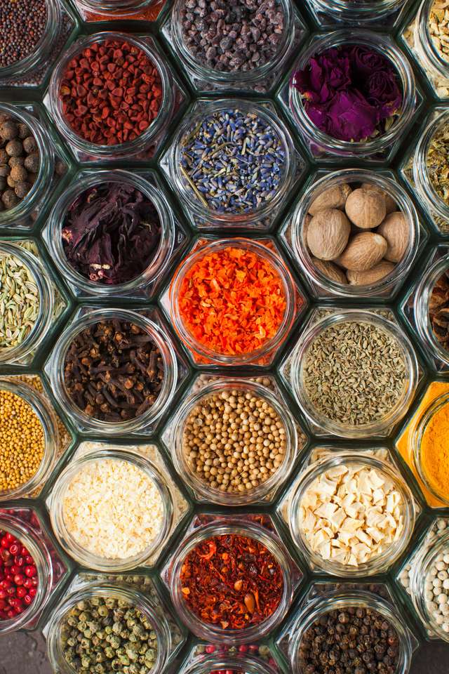 Assorted colorful spices and herbs in bottles puzzle online from photo