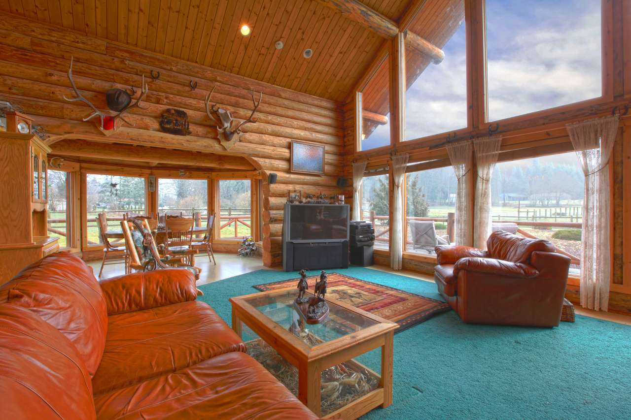Large living room in the rustic log cabin on the horse farm puzzle online from photo