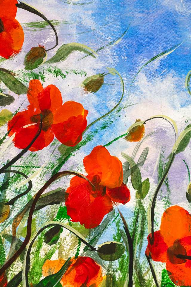 Red poppies in grass against a blue sky puzzle from photo