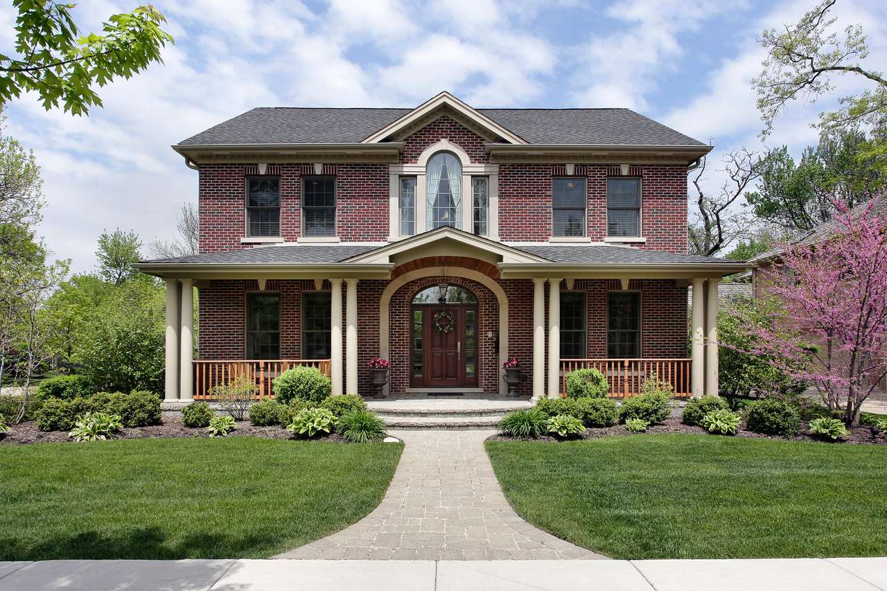 Brick home with white columns and arched entry online puzzle