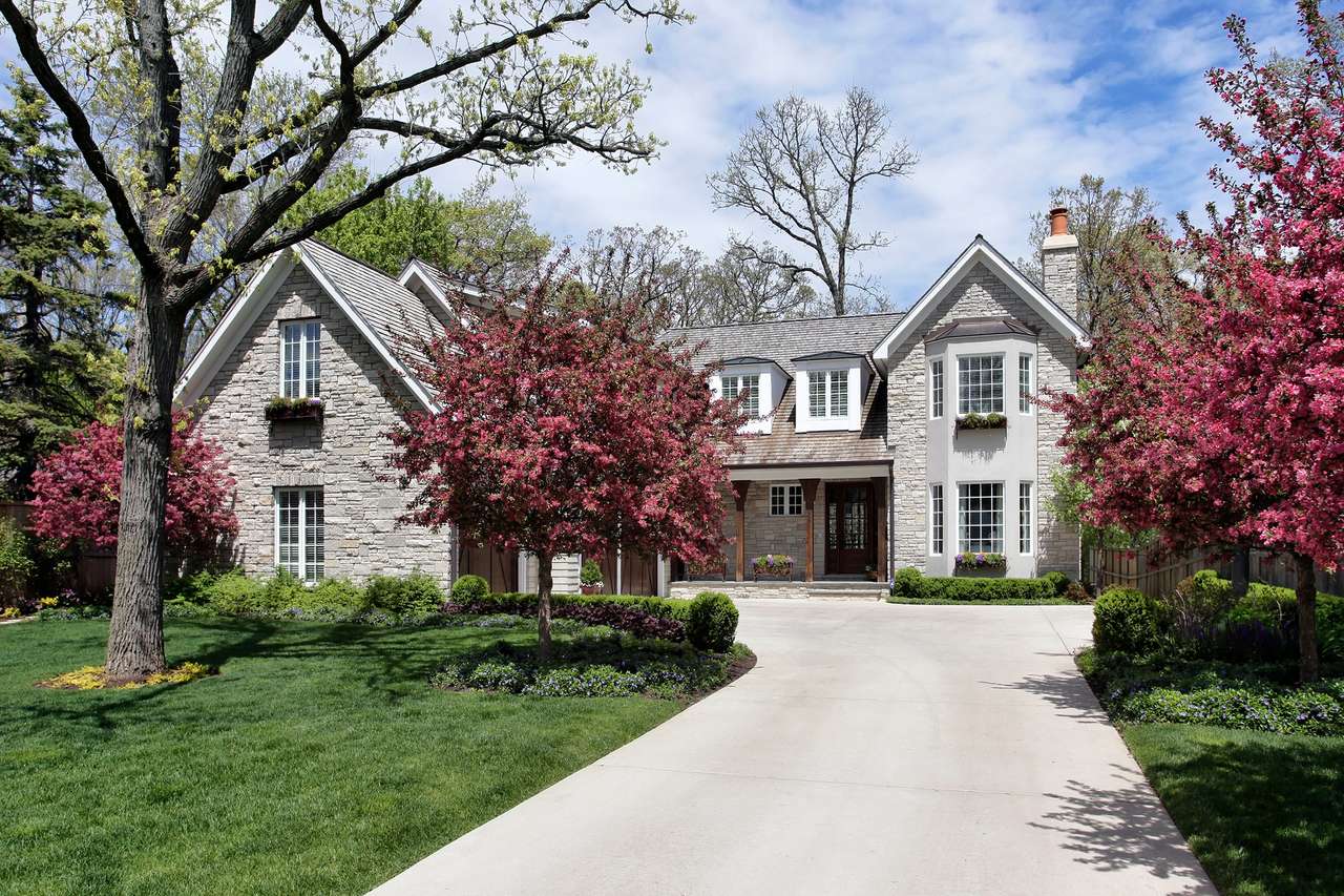 Stone home in suburbs with flowering trees puzzle online from photo