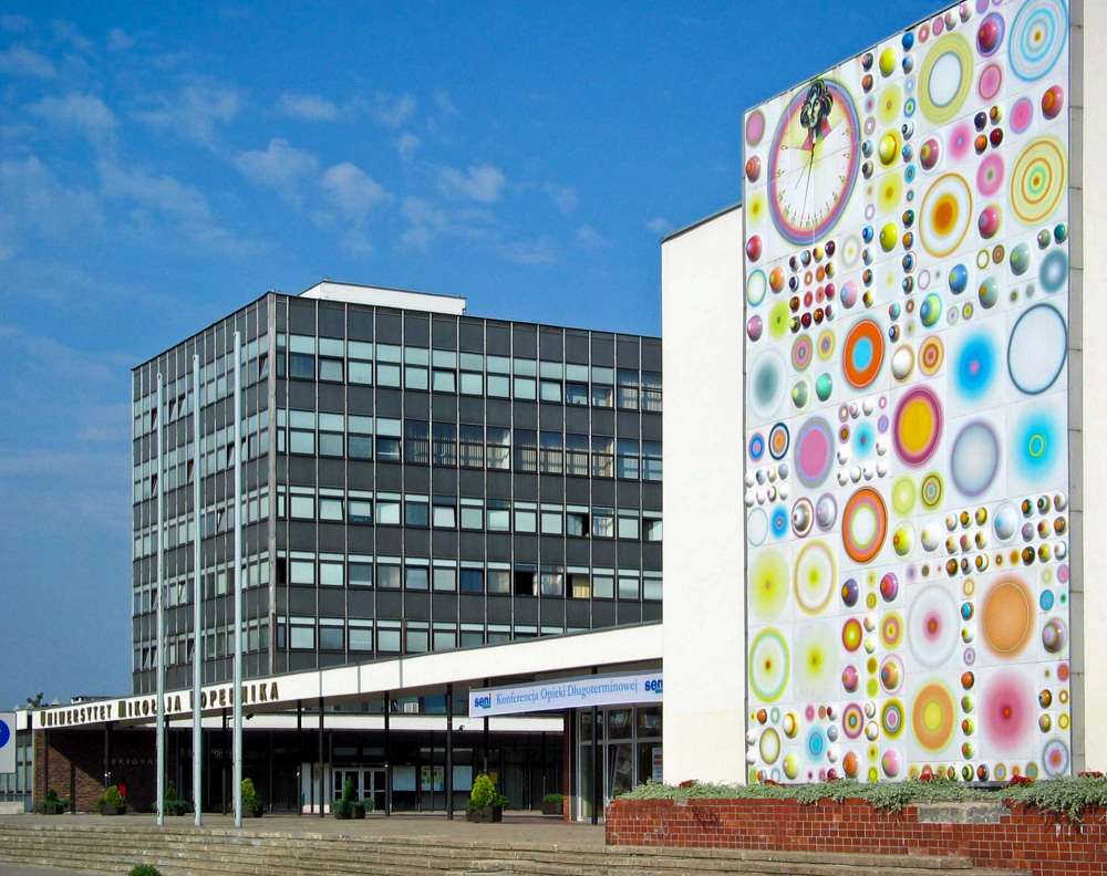 Panneau e o auditório da Universidade Nicolau Copérnico tendo como pano de fundo a reitoria puzzle online a partir de fotografia